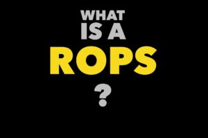 Graphic text reading ‘What is a ROPS?’ introducing information about Roll Over Protective Structures for heavy equipment safety by Cabs Rops & Attachments