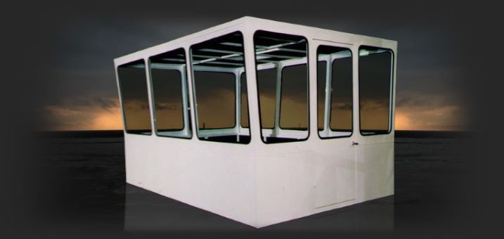 a white control cab built by cabs rops and attachments with 12 large windows, 3 on each side of the cab, on a dark sunset sky background