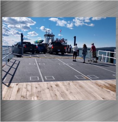 Photo of custom-built steel ferry loading ramps and railings in place with a stainless steel background