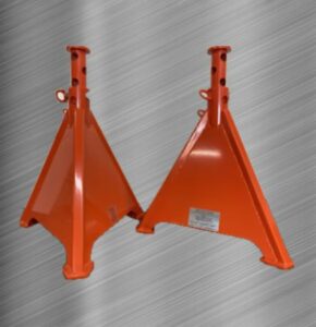 Two orange metal adjustable jackstands resting on a metal surface, highlighting their industrial stability and high visibility color.