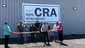 Cabs Rops & Attachments team and community members at ribbon-cutting ceremony outside the CRA facility in Iron River, Wisconsin, celebrating growth and innovation in custom steel and metal fabrication
